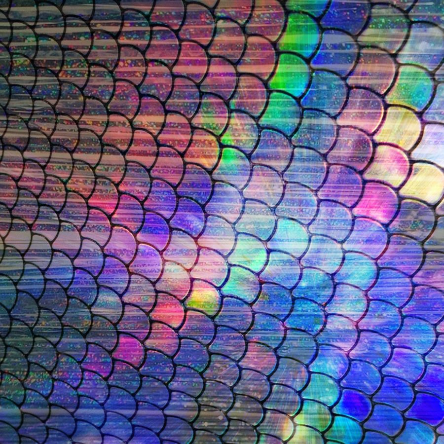 The meme is a screenshot of a "Meme Generator" output, featuring a colorful, swirling pattern of rainbow-colored scales that resemble the skin of a mythical creature, such as a dragon or a mermaid. The text "I can smell the desperation" appears in a small, bold font at the top of the image. The overall effect is a playful, whimsical, and humorous take on the idea of being desperate.